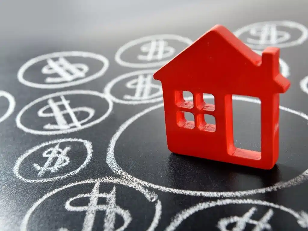 Model house with dollar signs around it, representing cost of living in Australia