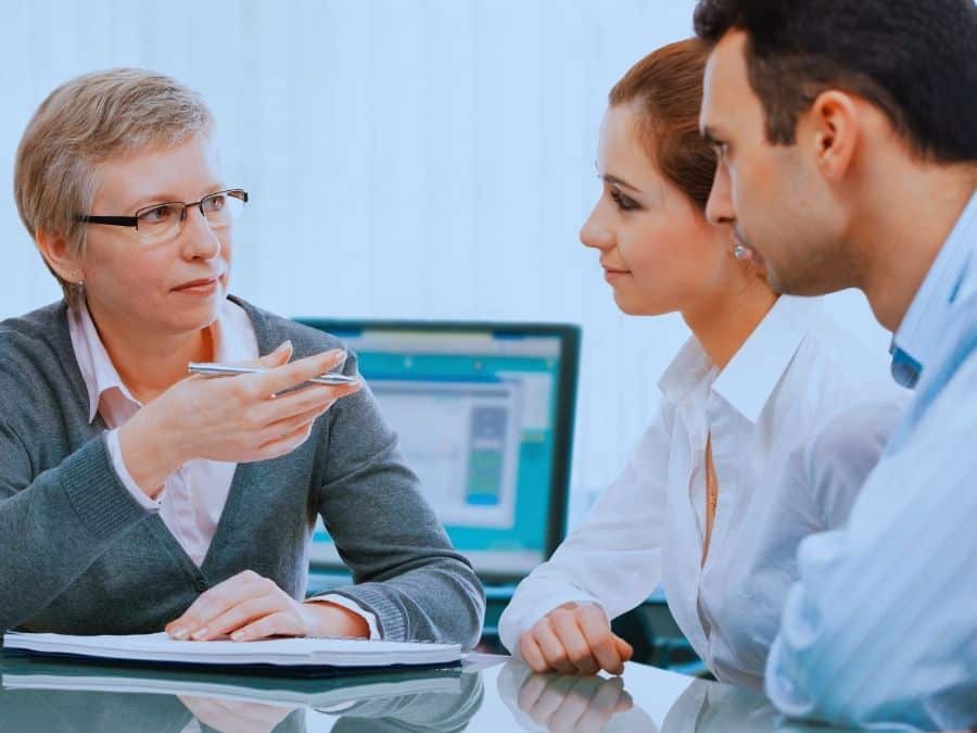 Couple meeting with financial adviser, learning the difference between free vs paid financial advice in Australia